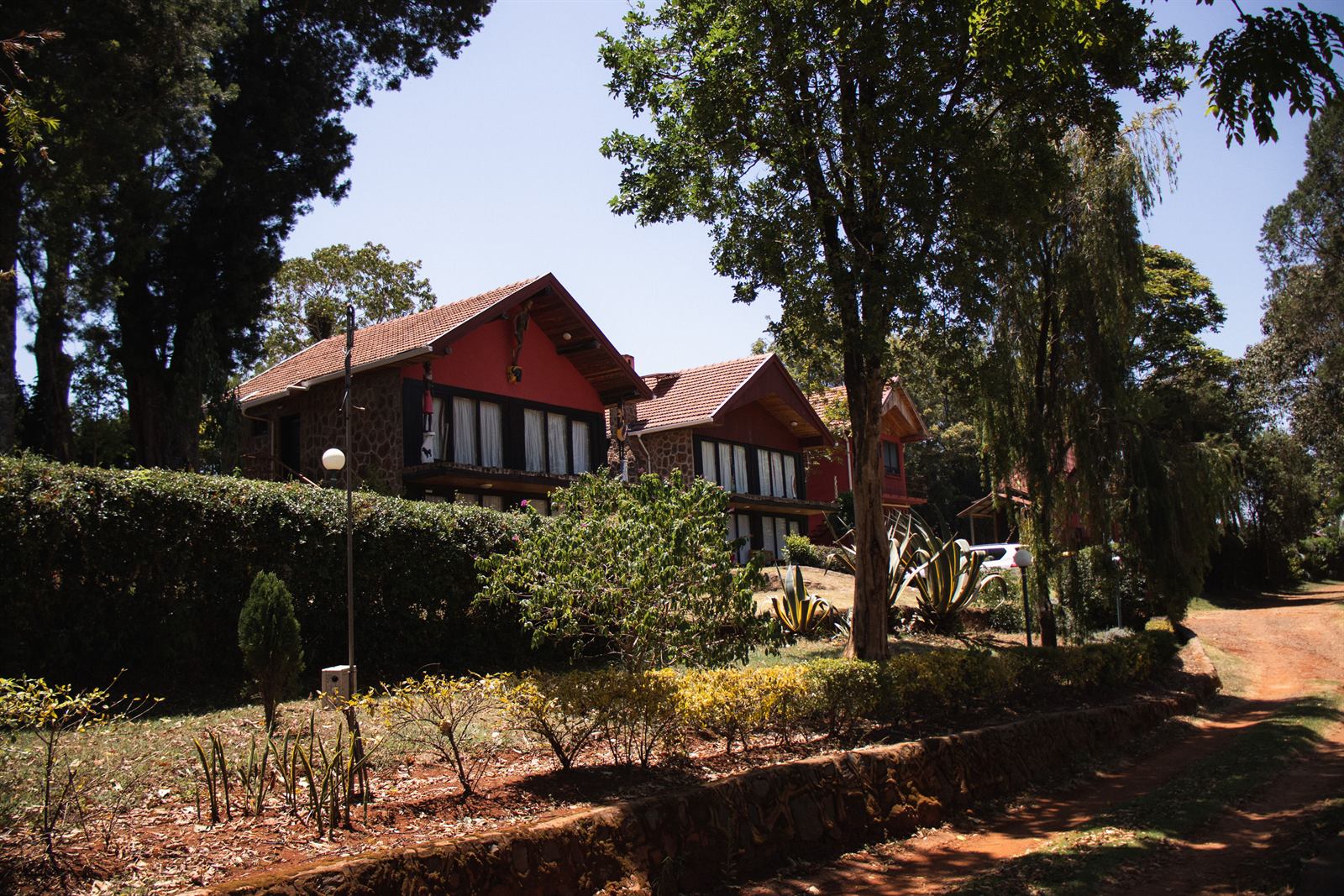 The lodge seen through the trees from the garden path