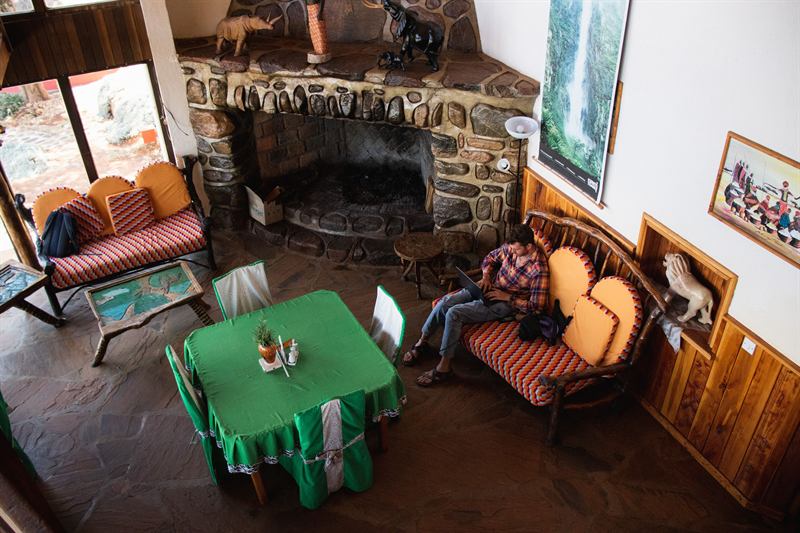 The lounge at Kerio View, seating around the stone fireplace